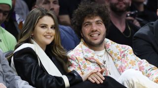 Selena Gomez and Benny Blanco smiling at a Laker's Game in 2024