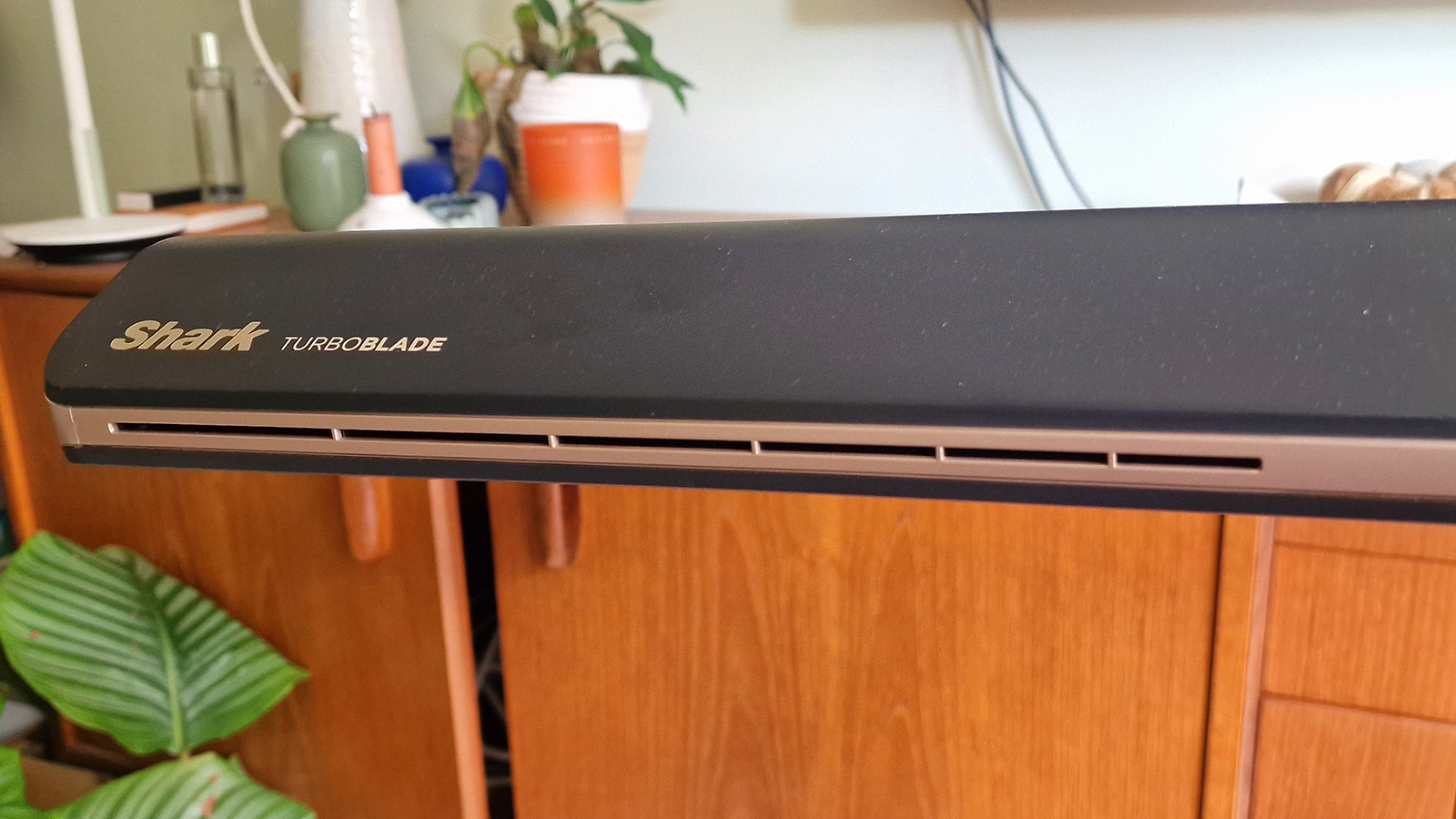 Shark TurboBlade in a living room in front of a walnut console