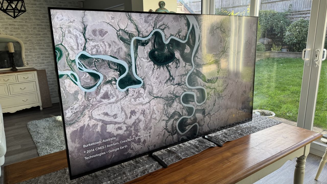 The Sony 65 Bravia 5 from a left angle, pictured on a wooden cabinet