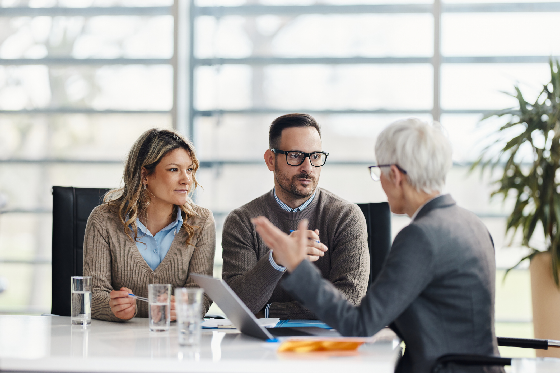 A couple discusses finances with an advisor.