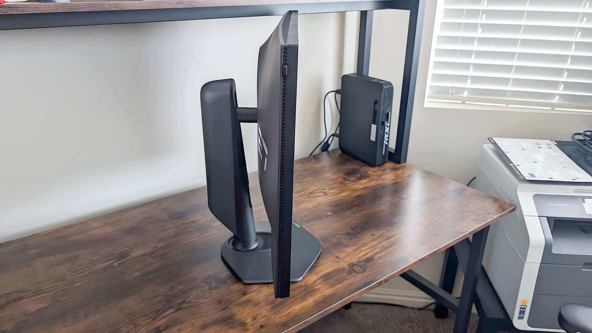 Profile shot of the Alienware AW2725QF Gaming Monitor as it sits on a desk.