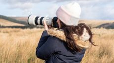 a woman using a camera outside