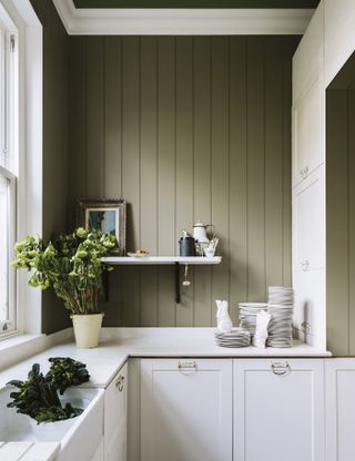 A white kitchen by Farrow & Ball with khaki green painted shiplap wall decor