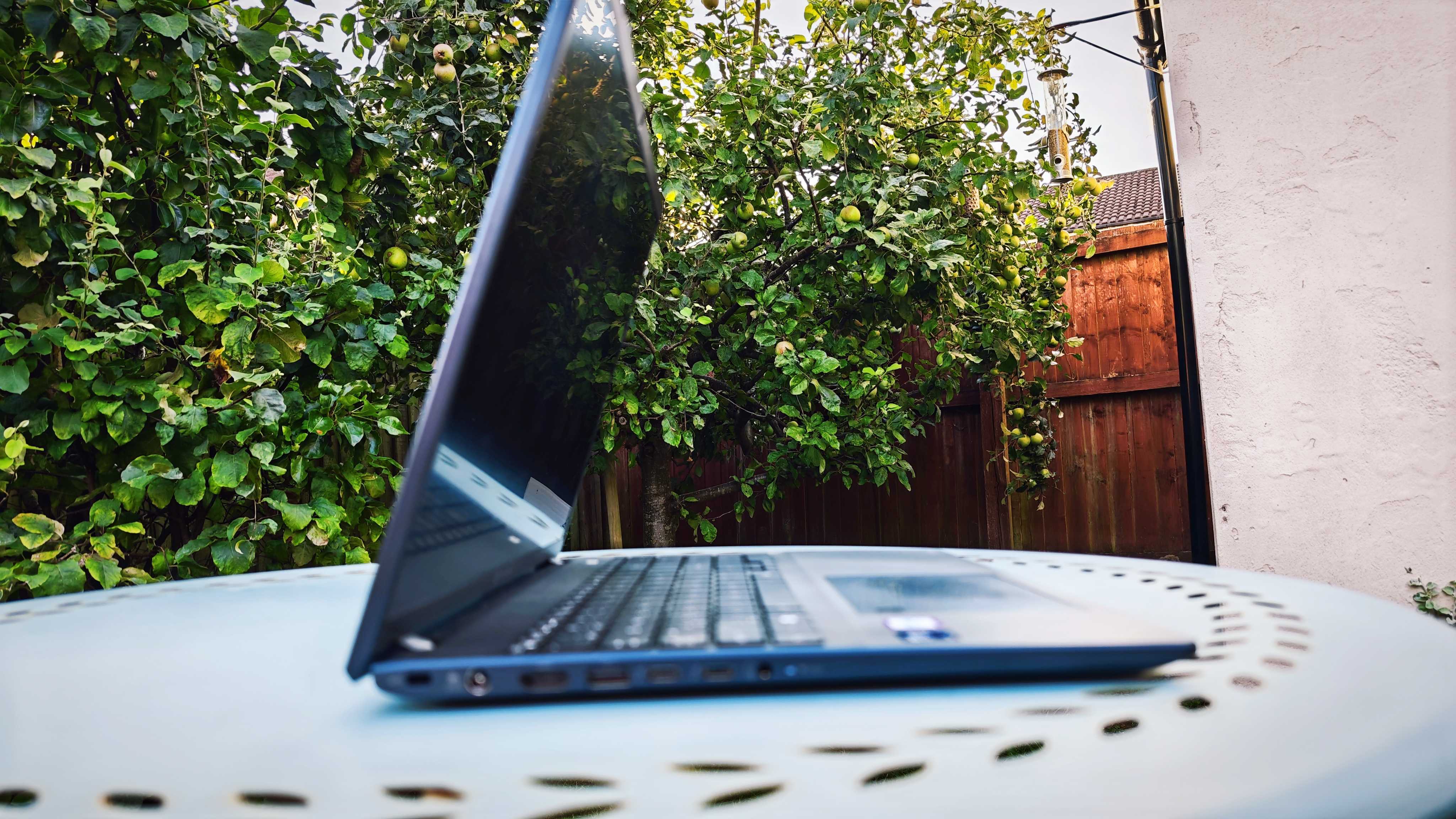 A dark blue Dynabook Tecra A60-M laptop on a garden table