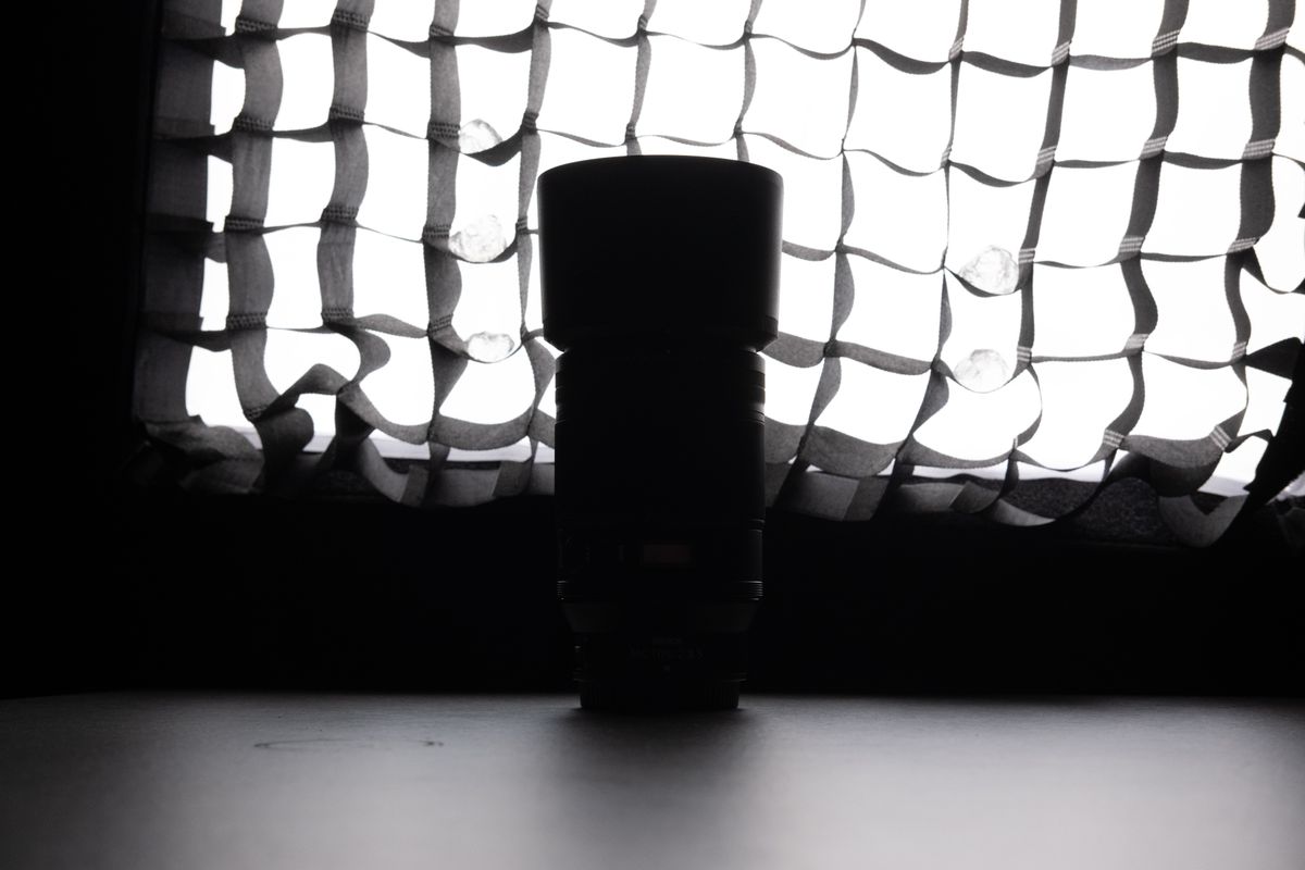 A backlit photo of a Nikon lens in front of a lit softbox, with no edits made in post production.