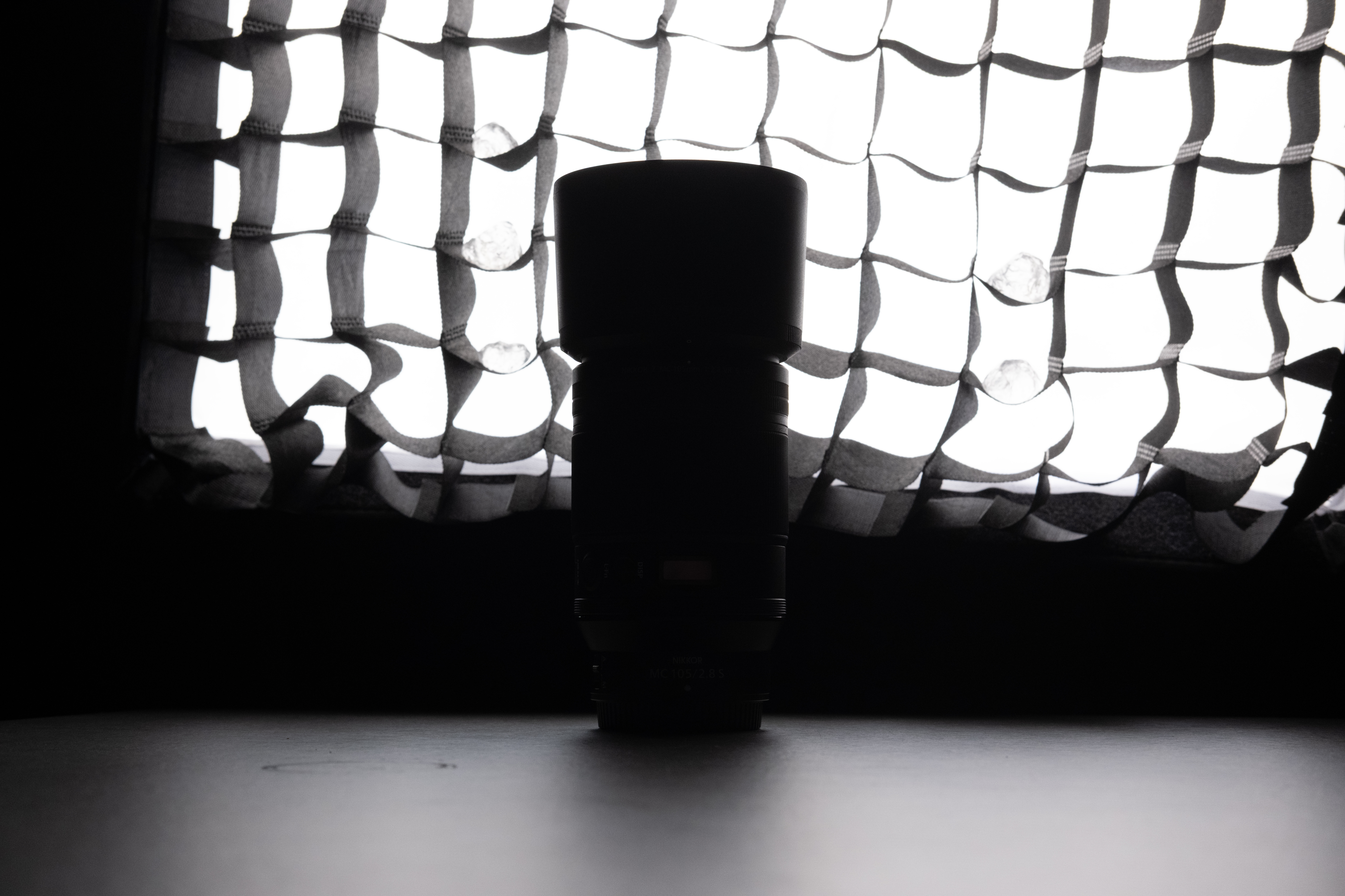 A backlit photo of a Nikon lens in front of a lit softbox, with no edits made in post production.