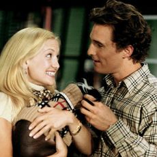 kate hudson holding a dog and smiling with matthew mcconaughey in a still from how to lose a guy in 10 days