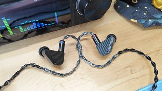 The Truthear Pure in various positions on a desktop. 