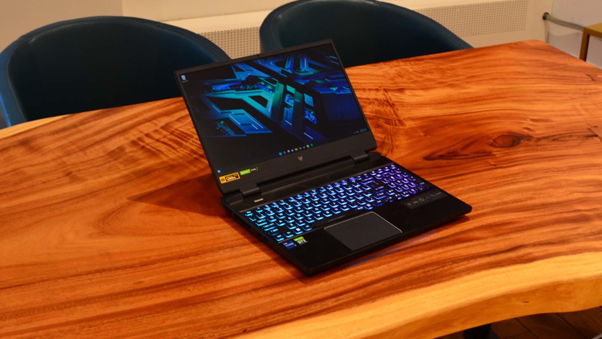 An Acer Predator Helios 300 (2022) sitting on a wooden table in a commissary