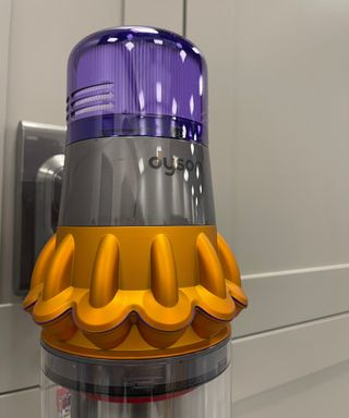 Close up of the main purple, orange and gray vacuum unit for the Dyson V15 Detect