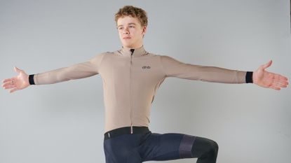 A man in cycling kit doing stretches