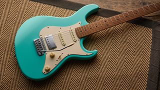 A Cort G200SE electric guitar lying on a rug