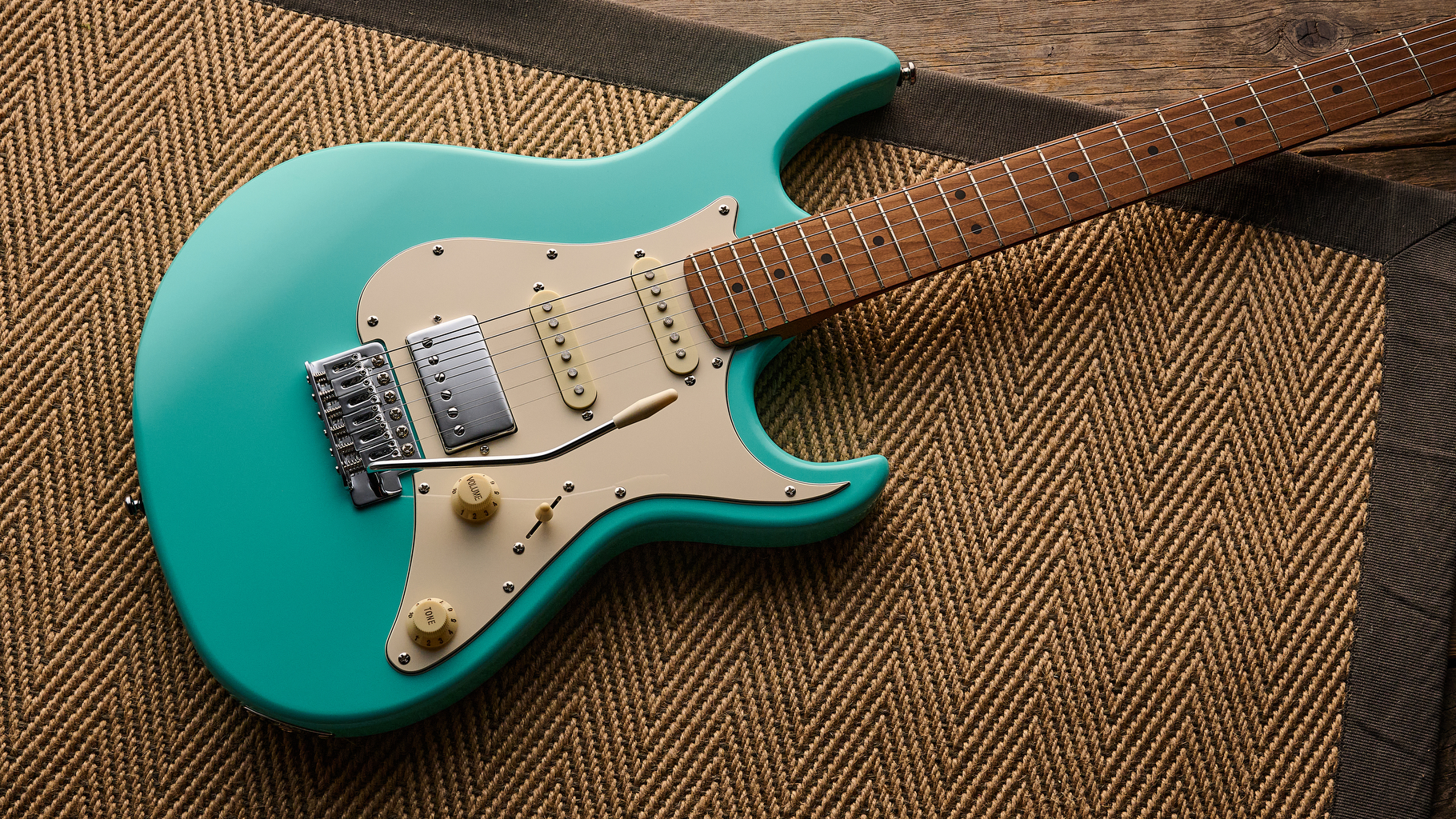 A Cort G200SE electric guitar lying on a rug