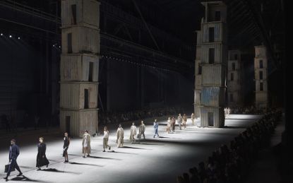 Models walking on runway with concrete towers as a backdrop at Milan&#039;s Pirelli Hanger Bicocca