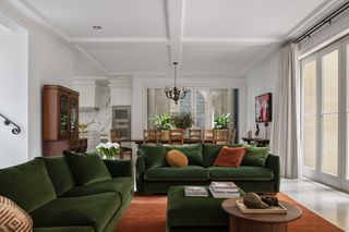 A living room with two armchairs placed adjacent to create a subtle partition