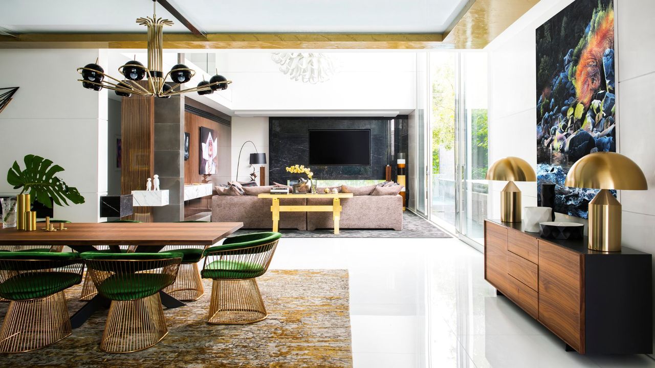 Toorak, Australia. A home with classy gold features and a rug under a dining table and chairs 