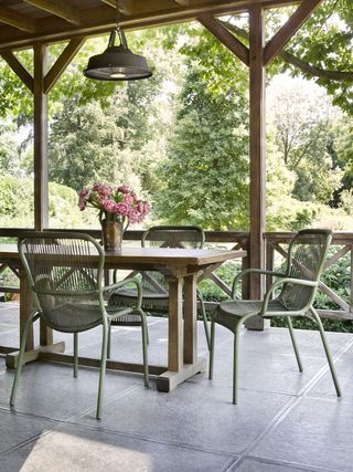 Metal Pendant light illuminates outdoor dining area