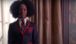 Samantha Ware in a suit and tie performing on Glee.