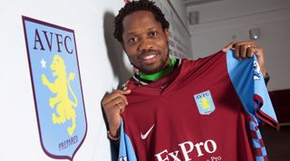 BIRMINGHAM, ENGLAND - JANUARY 15: Jean Makoun holds up his shirt after announcing signing with Aston Villa at the Aston Villa training ground Bodymoor Heath on January 15, 2011 in Birmingham, England. (Photo by Neville Williams/Aston Villa FC via Getty Images)