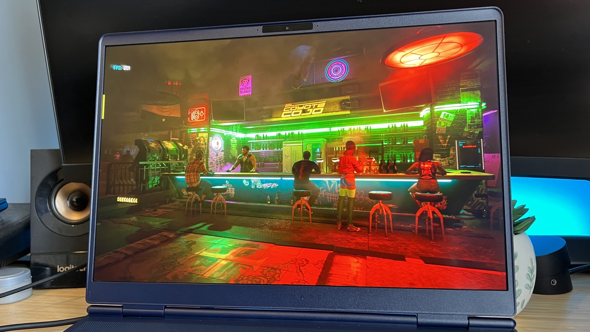 Close up on display of Alienware 16X Aurora 2026 gaming laptop showing Cyberpunk 2077 benchmark running