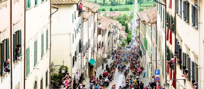 The peloton charges into the Umbrian town of Anghiari during the Giro d'Italia.