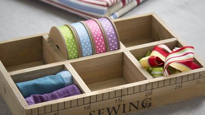 wooden sewing kit box tape and fabric