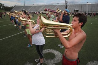 The student marching band practices on the campus of Southern Illinois University before participating in solar eclipse festivities at Saluki Stadium in Carbondale.