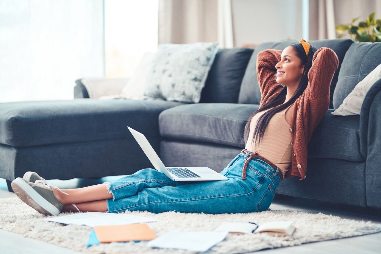 Young woman on her laptop wondering how to pay off her debts fast