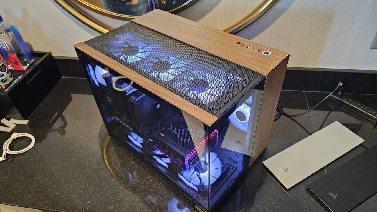 Photography of Corsair's 2500X MATX dual chamber PC case, with its upcoming A115 Air Cooler inside.