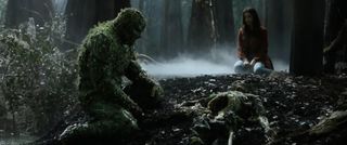 Swamp Thing and Abby Arcane look sadly over the skeleton of Alec Holland