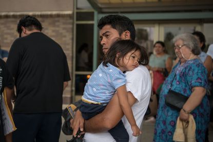 A migrant child and her father.