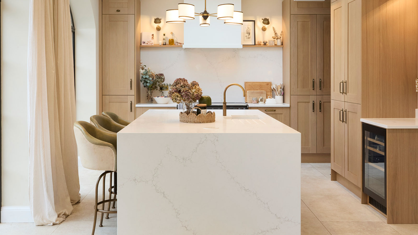 modern wooden kitchen with white marble kitchen island and arched windows