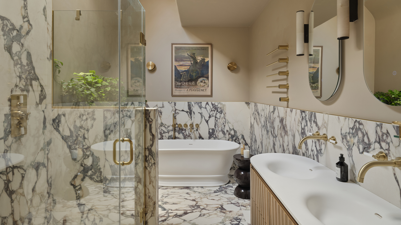 marble clad bathroom design with freestanding bath and double sink
