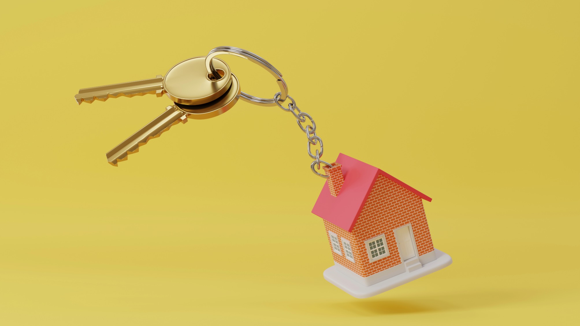 Toy house keychain on yellow background