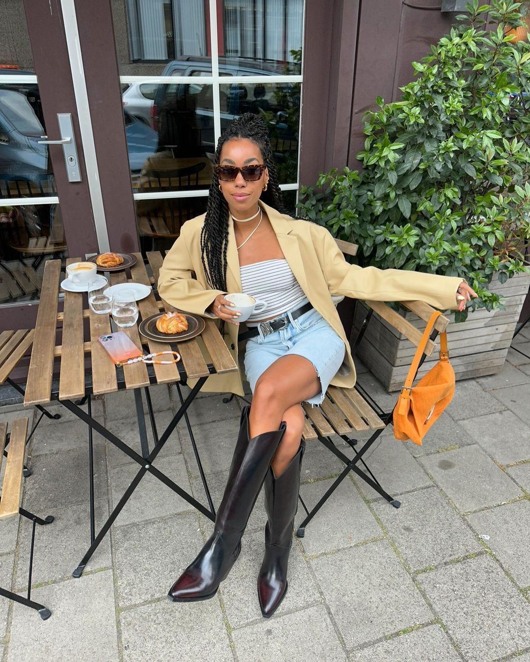 @amaka.hamelijnck wearing long shorts, knee high boots and a blazer