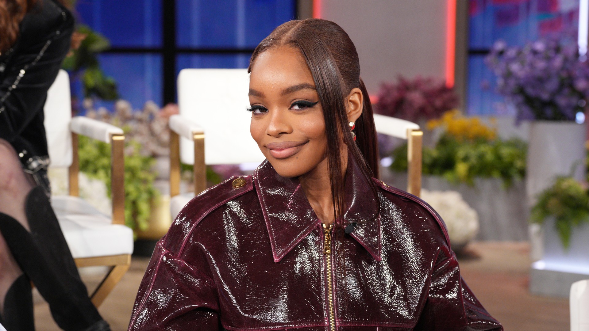 a black woman with brown hair pictured on a talk show set