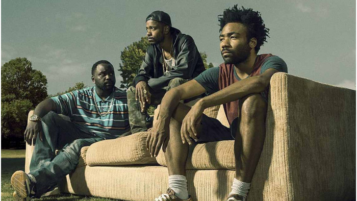 Donald Glover, LaKeith Stanfield and Brian Tyree Henry sat on a sofa