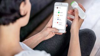 Best digital thermometers 2020: a person uses the Withings ThermoScan smart thermometer to check if she has a fever