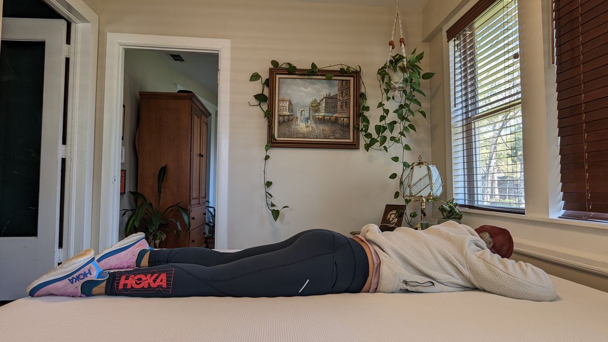 Our tester lying on the Essentia Stratami organic mattress to test its comfort and support