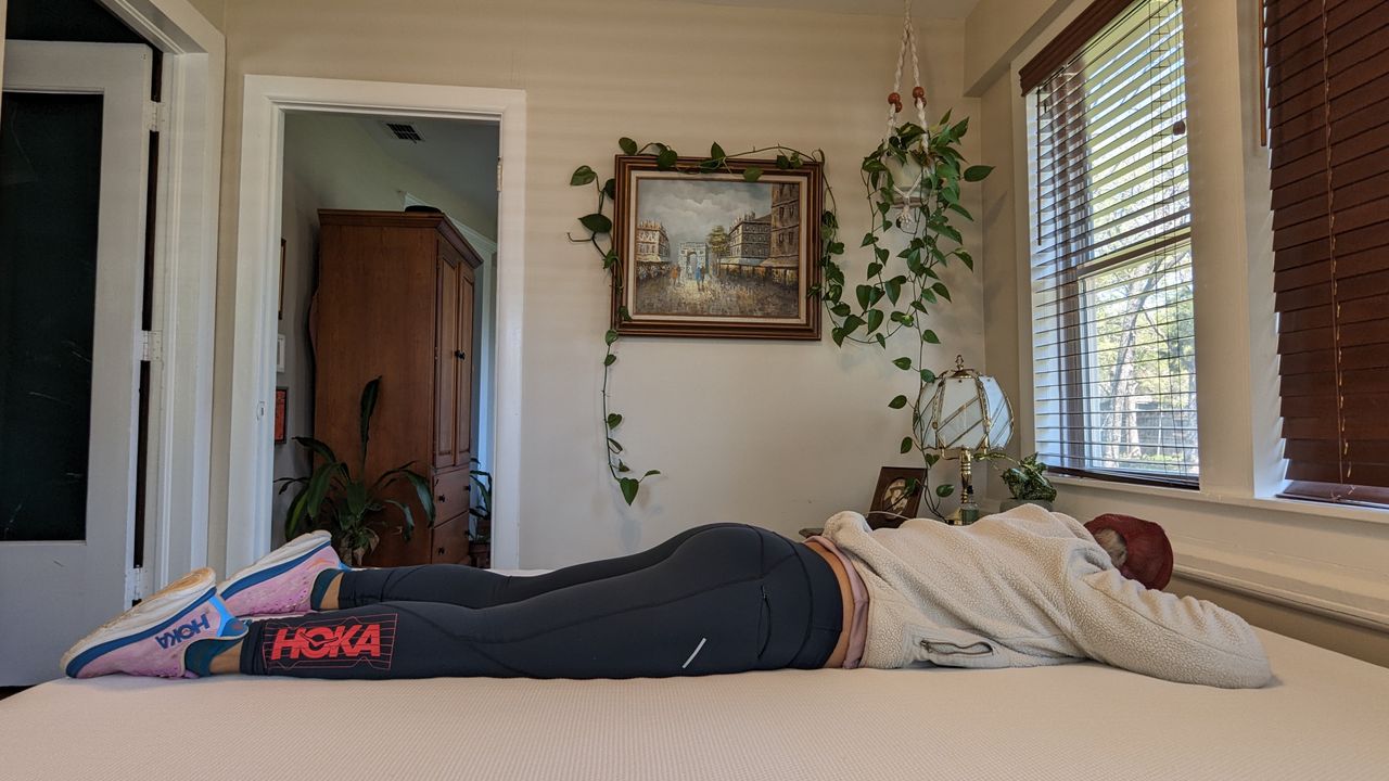 Our tester lying on the Essentia Stratami organic mattress to test its comfort and support