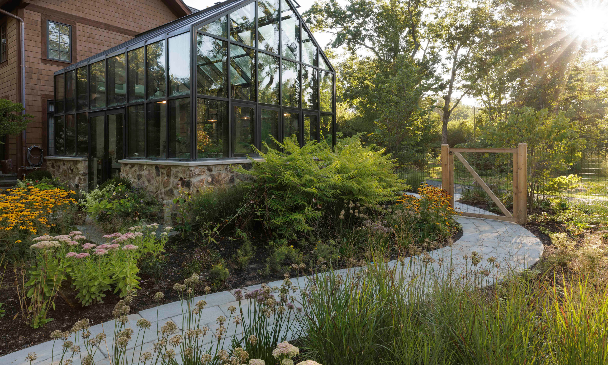 Fall planting bordering curved pathway in garden