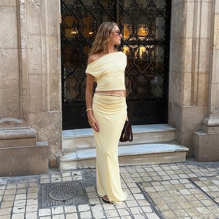 Magdalena wears a butter yellow skirt and top set 