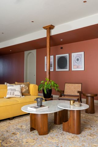 A terracotta wall paired with a yellow sofa