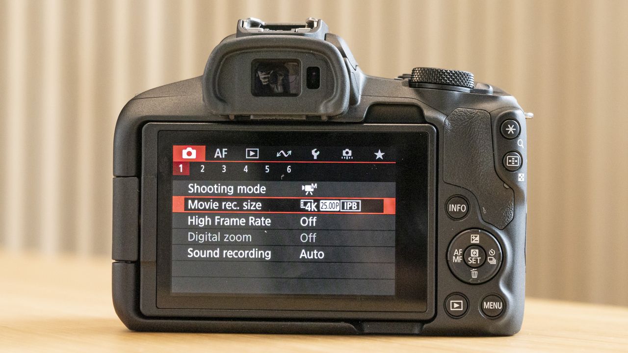 Rear of Canon EOS R50 on a table with screen on