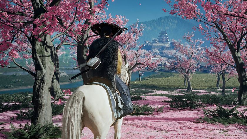 Ghost of Yotei gameplay showing Atsu sitting on her horse between bright pink cherry blossoms, looking at a distant fortification built against a mountain