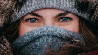 Close up of Eeva Mäkinen's eyes wearing winter clothing including a grey wollen scarf over her mouth