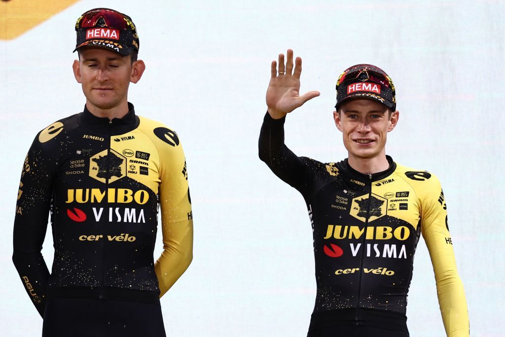 JumboVismas Danish rider Jonas Vingegaard R waves on stage flanked by JumboVismas Belgian rider Tiesj Benoot L during the official teams presentation near the Guggenheim Museum Bilbao in Bilbao northern Spain on June 29 2023 two days prior to the start of the 110th edition of the Tour de France cycling race Photo by AnneChristine POUJOULAT AFP Photo by ANNECHRISTINE POUJOULATAFP via Getty Images