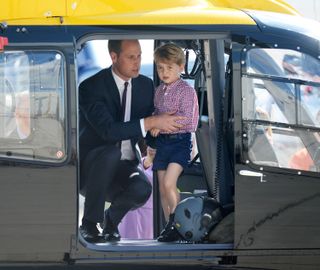 Prince George of Cambridge, Prince William, Duke of Cambridge look in a helicopter as they depart from Hamburg airport