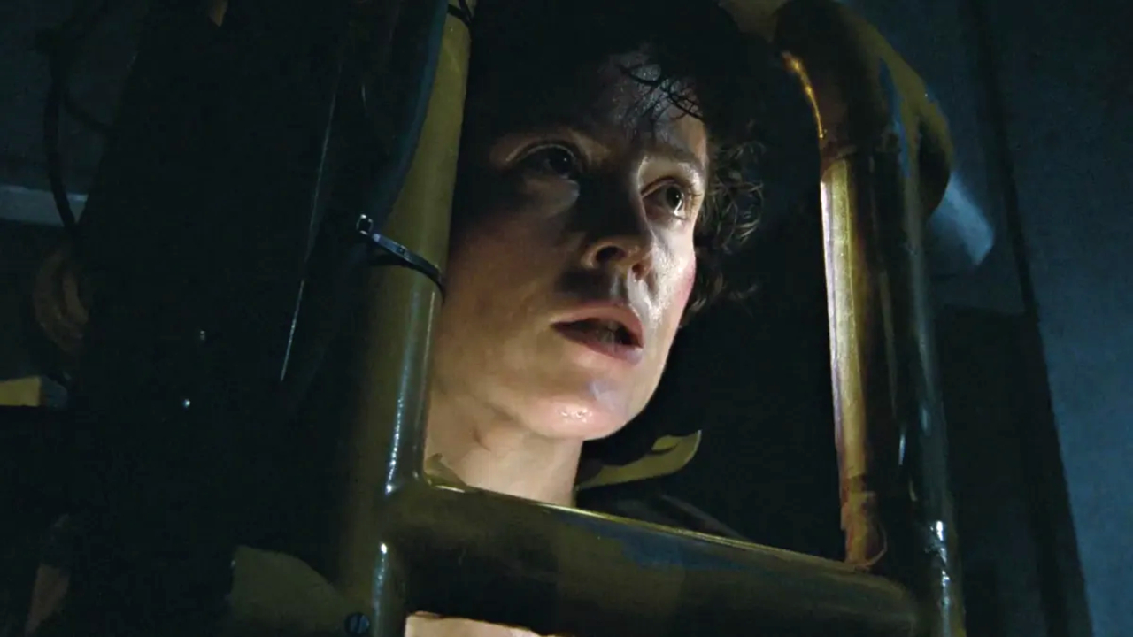 Sigourney Weaver stands in her power loader looking angry in Aliens.