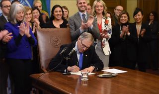 Governor Jay Inslee ‏signs a Washington State bill to "protect an open internet in Washington." Credit: Gov. Jay Inslee / Legislative Support Service